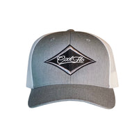 Grey and white trucker cap with an embroidered Cool Flo logo in a diamond design.