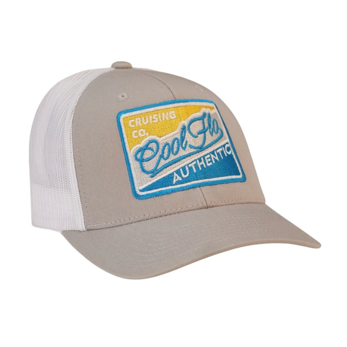 Cool Flo Authentic Cruising Co - Trucker cap with silver/grey front and white mesh a with a yellow, white, silver and turquoise embroidered badge design