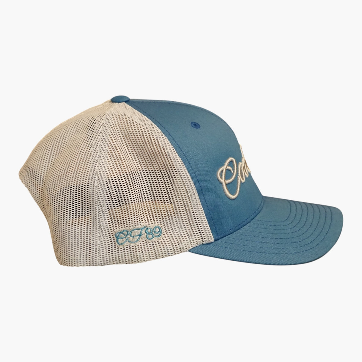 Side-on image of Cool Flo blue and silver two-tone trucker cap with embroidered embellishments - 3D silver logo on the front and blue and silver CF89 on the side.