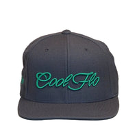 Front view of a Cool Flo snapback cap in Dark Grey featuring a raised 3D Green embroidered Script logo and flat visor