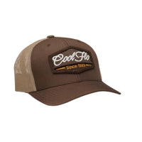 Cool Flo brown and khaki trucker cap with brown, white and orange 3D puff embroidered badge sewn onto the front.