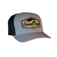 Grey and black trucker cap with Cool Flo Since 1989 puff-embroidered badge sewn onto front.