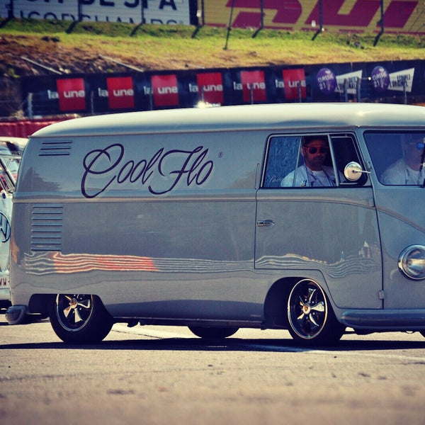 At the race-track. Cool Flo grey 1954 VW bus with dark red Cool Flo logo on the side.