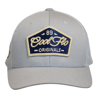Front view of a Cool Flo 89 Originals trucker cap in Silver featuring an embroidered 89 Originals badge in Navy, Gold and White and a curved visor
