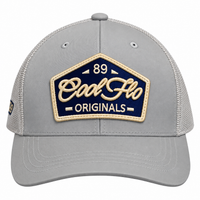 Front view of a Cool Flo 89 Originals trucker cap in Silver featuring an embroidered 89 Originals badge in Navy, Gold and White and a curved visor.