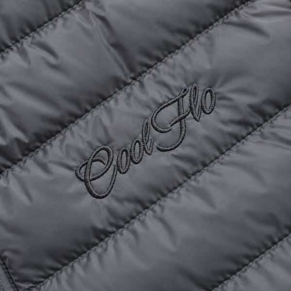 Close-up of tonal Cool Flo Script embroidery on an anthracite quilted jacket.
