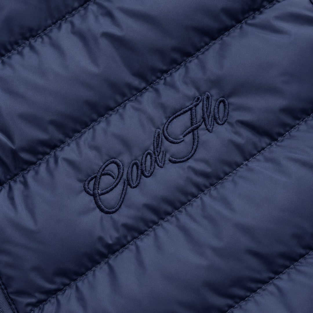 Close-up of tonal Cool Flo Script embroidery on a navy Cool Flo quilted jacket.