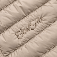 Close-up of tonal Cool Flo Script embroidery on a desert dust quilted jacket.