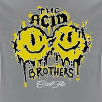 A close-up of a grey t-shirt featuring a yellow and black 'smileys' graphic print on the front with the text 'THE ACID BROTHERS' and  a 'Cool Flo' script logo.