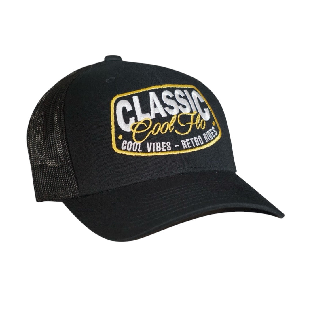 Cool Flo black trucker cap with embroidered yellow and white 'Classic, cool vibes, retro rides' design.