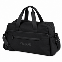 A black weekender bag with dual top handles, a front zippered pocket, and a detachable shoulder strap, featuring the script brand name 'Cool Flo' embroidered on the front, set against a plain white background.