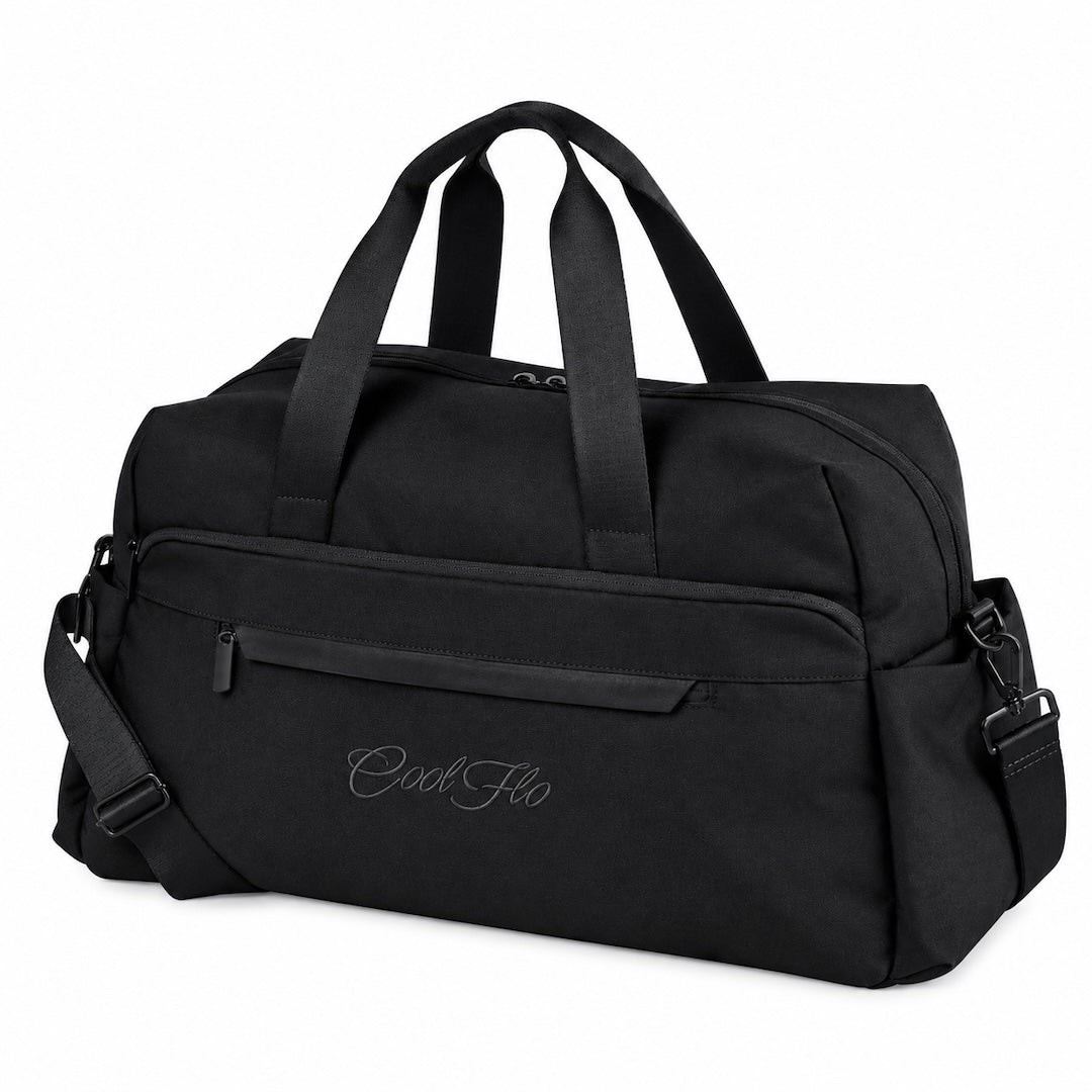 A black weekender bag with dual top handles, a front zippered pocket, and a detachable shoulder strap, featuring the script brand name 'Cool Flo' embroidered on the front, set against a plain white background.