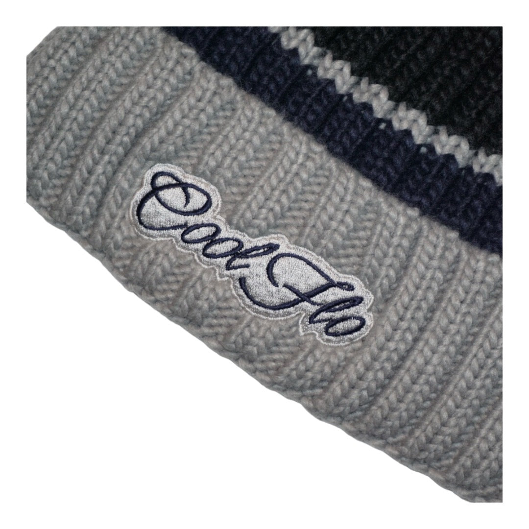 Chunky-knit bobble hat with script logo and large pom pom. Navy blue and grey.