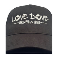 Black baseball cap with embroidered white 'Love Dove Generation' on the front_close up of embroidered logo.