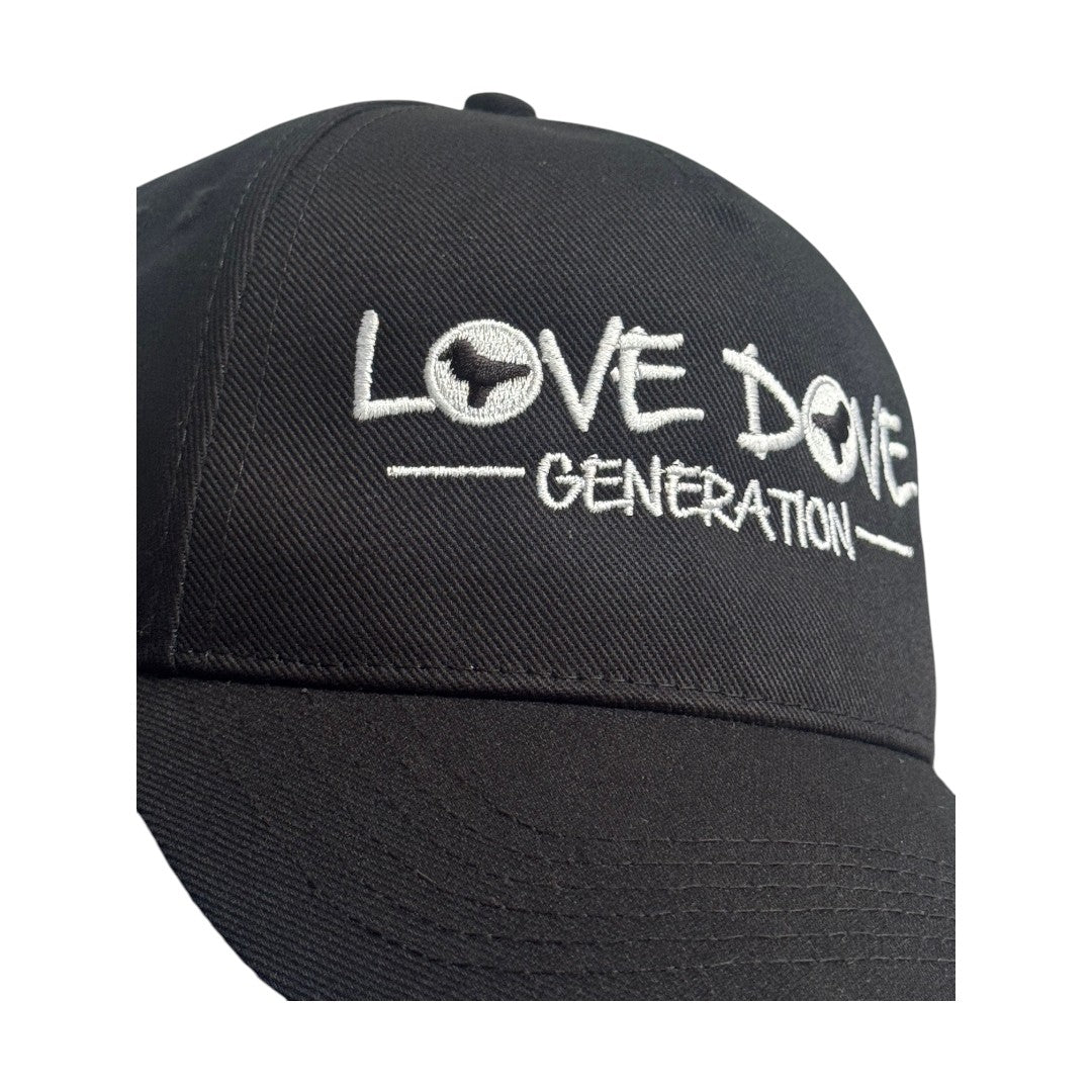 Black baseball cap with embroidered white 'Love Dove Generation' on the front_close up of embroidered logo.