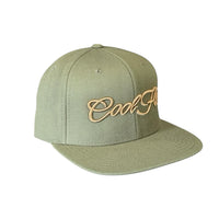 Buck-green snapback cap with bronze 3D embroidered Cool Flo script logo on the front.