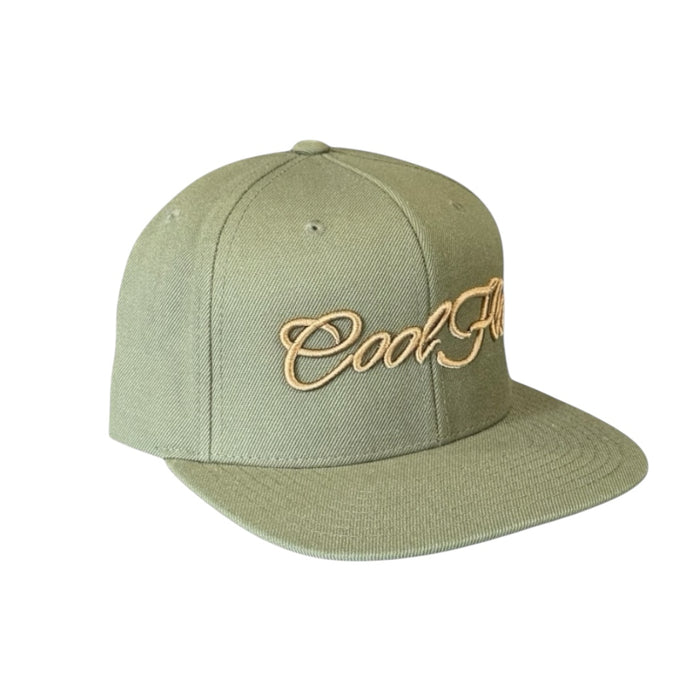 Buck-green snapback cap with bronze 3D embroidered Cool Flo script logo on the front.