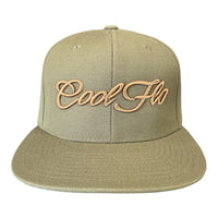 Buck-green snapback cap with bronze 3D embroidered Cool Flo script logo on the front.