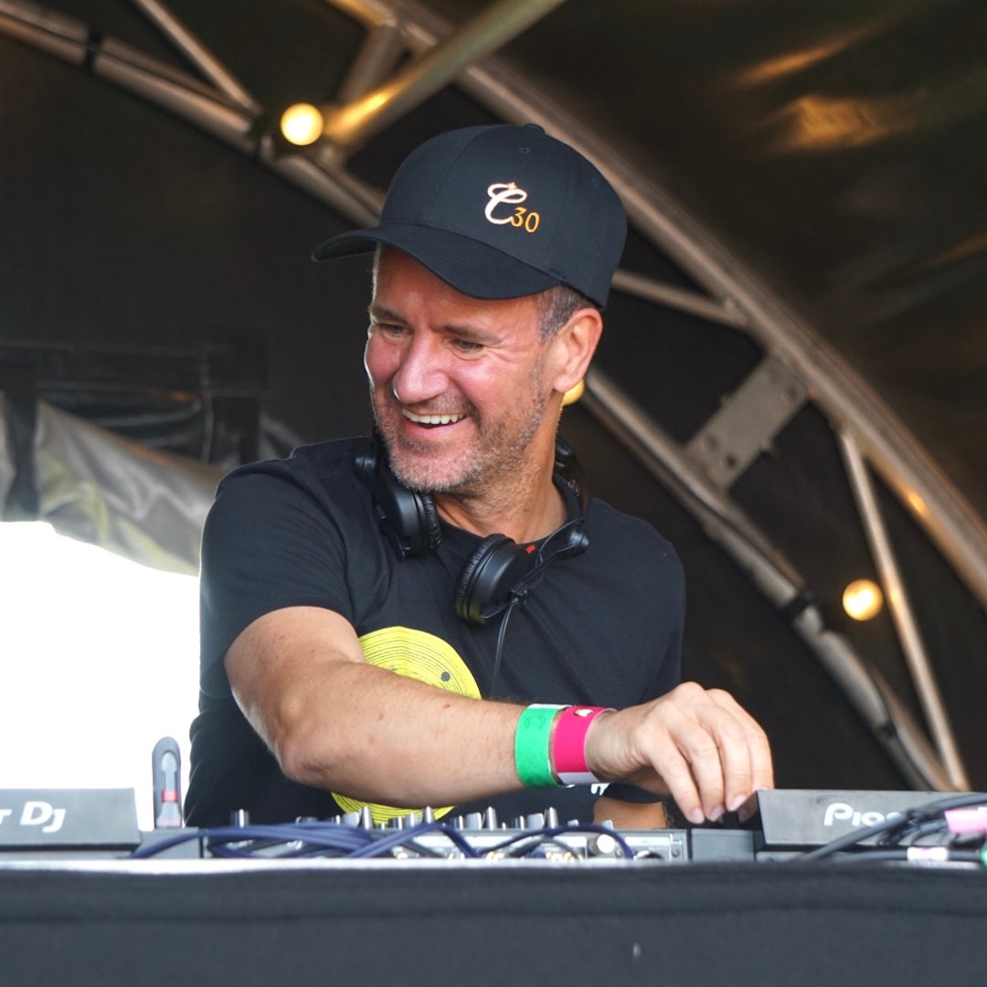 DJ on the decks wearing a Clockwork Orange C30 black baseball cap