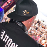 Rear shot of Clockwork Orange DJ wearing a black C30 snapback cap with crowds in front.