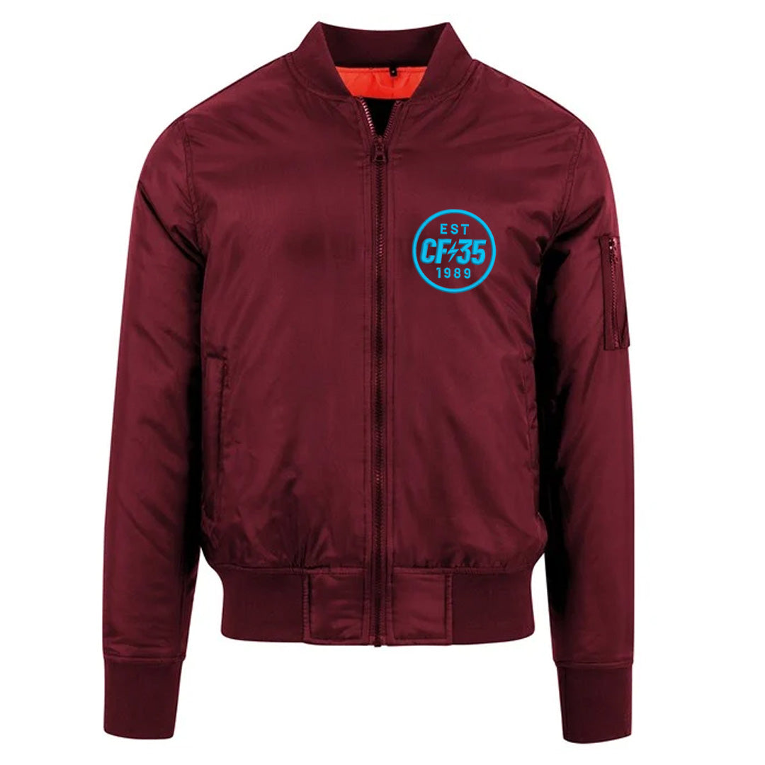 CF35 maroon bomber jacket with blue CF35 logo on left and contrast orange lining.