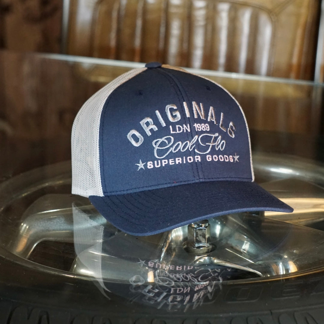 Cool Flo navy and silver/grey trucker cap with silver/grey and pink embroidered 'Originals' design.