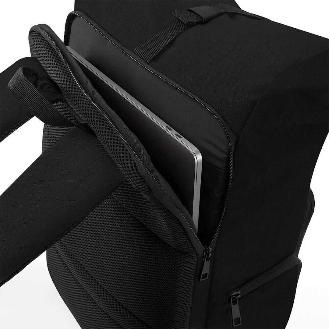Close-up of a black backpack with an open front compartment showing a silver laptop inside, on a clean white background.