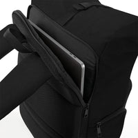 Close-up of a black backpack with an open front compartment showing a silver laptop inside, on a clean white background.
