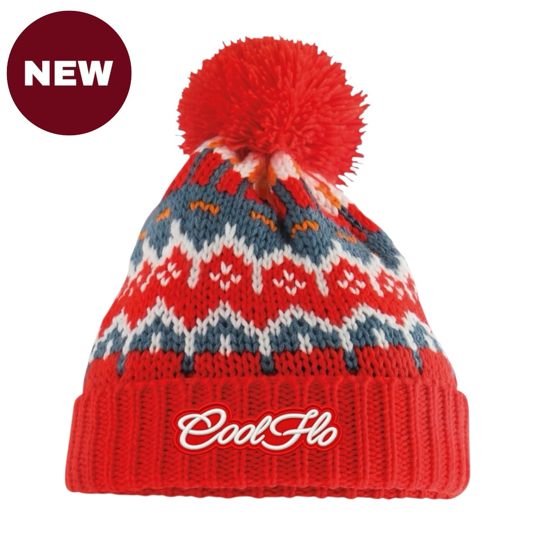 A red knit pom-pom beanie with a Fair Isle pattern in red, blue, and white, featuring the brand name 'CoolFlo' embroidered on the front cuff. A dark red 'NEW' badge is in the top-left corner.