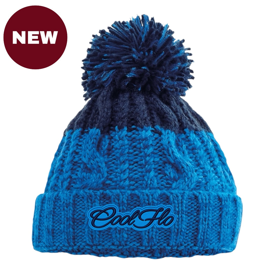 A blue and navy cable-knit pom-pom beanie with 'Cool Ho' embroidered on the front cuff, shown on a white background with a red 'NEW' badge in the top-left corner.