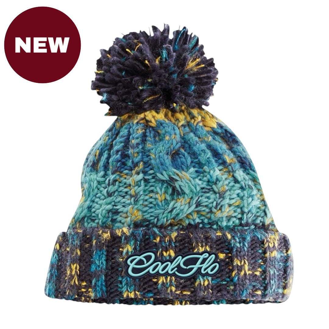 A marled knit pom-pom beanie in teal, navy, and yellow, featuring a ribbed cuff with the 'Cool Flo' logo embroidered in teal.