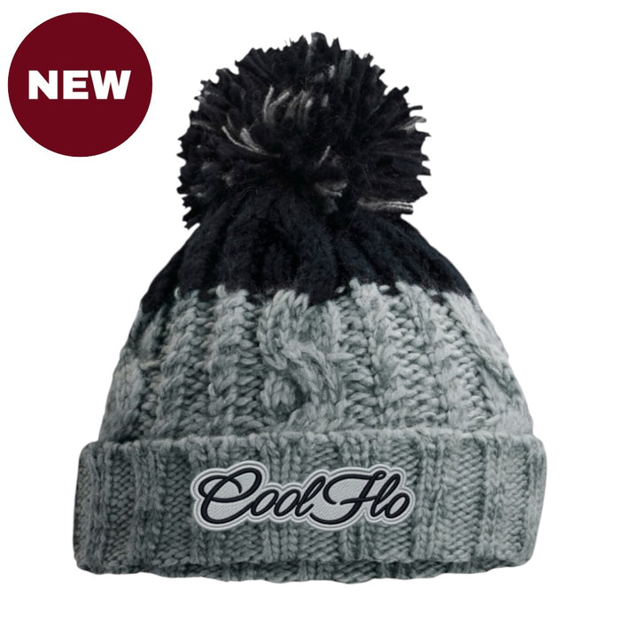 A grey and black cable-knit pom-pom beanie with a folded cuff featuring the embroidered 'Cool Ho' logo, shown on a white background with a red 'NEW' badge in the top-left corner.