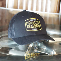 Cool Flo Classics black trucker cap with white yellow and black embroidered badge design.