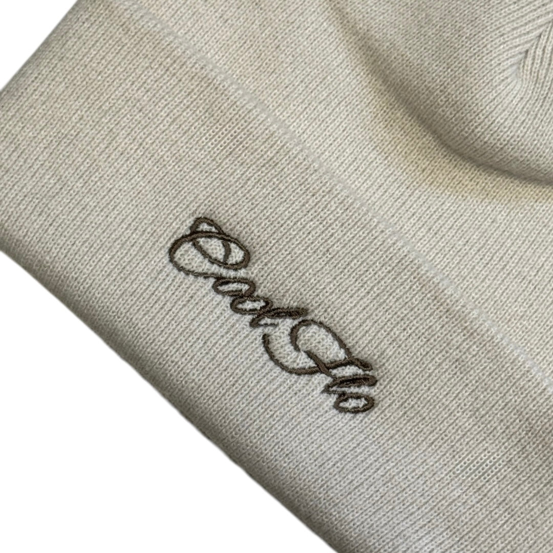 Close-up of Cool Flo Cuffed Beanie Hat in an almond colour with a brown Cool Flo embroidered logo on the cuff.
