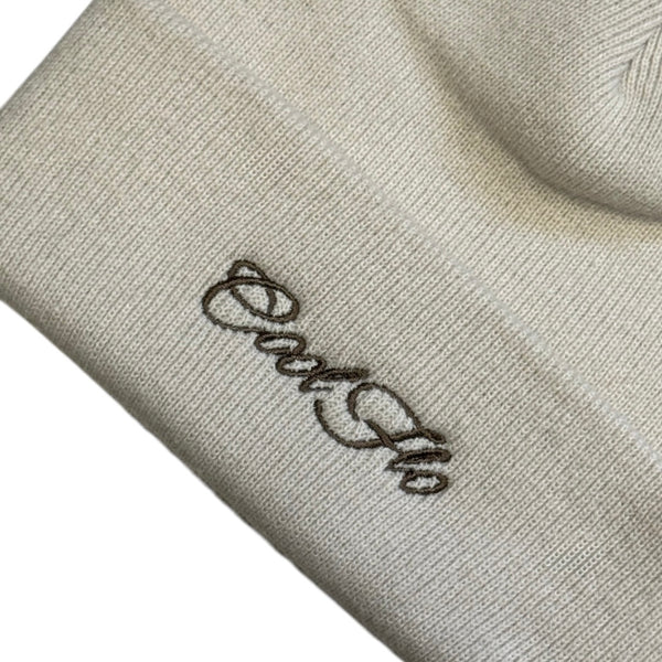 Close-up of Cool Flo Cuffed Beanie Hat in an almond colour with a brown Cool Flo embroidered logo on the cuff.
