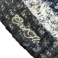 Close-up of Cool Flo Morzine bobble hat in Midnight Summit colour way with an embroidered logo on the cuff.