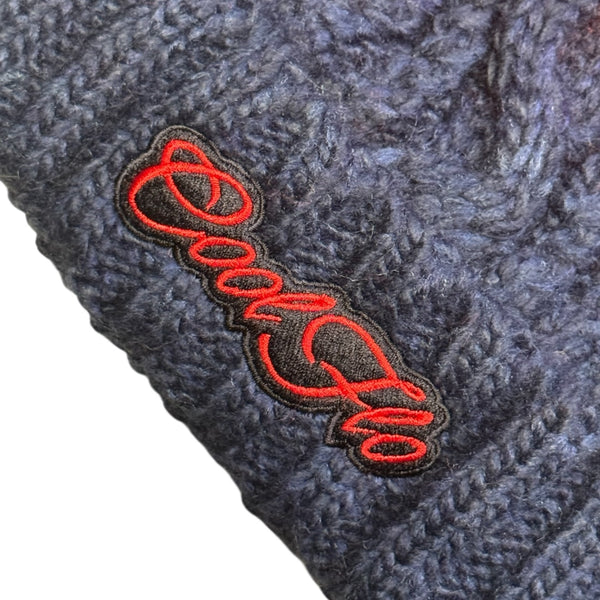 Close-up of Cool Flo Navy/Red Chamonix bobble hat with matching embroidered logo.