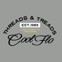 Close up of Threads & Treads print in black, white and yellow on a misty grey t-shirt.