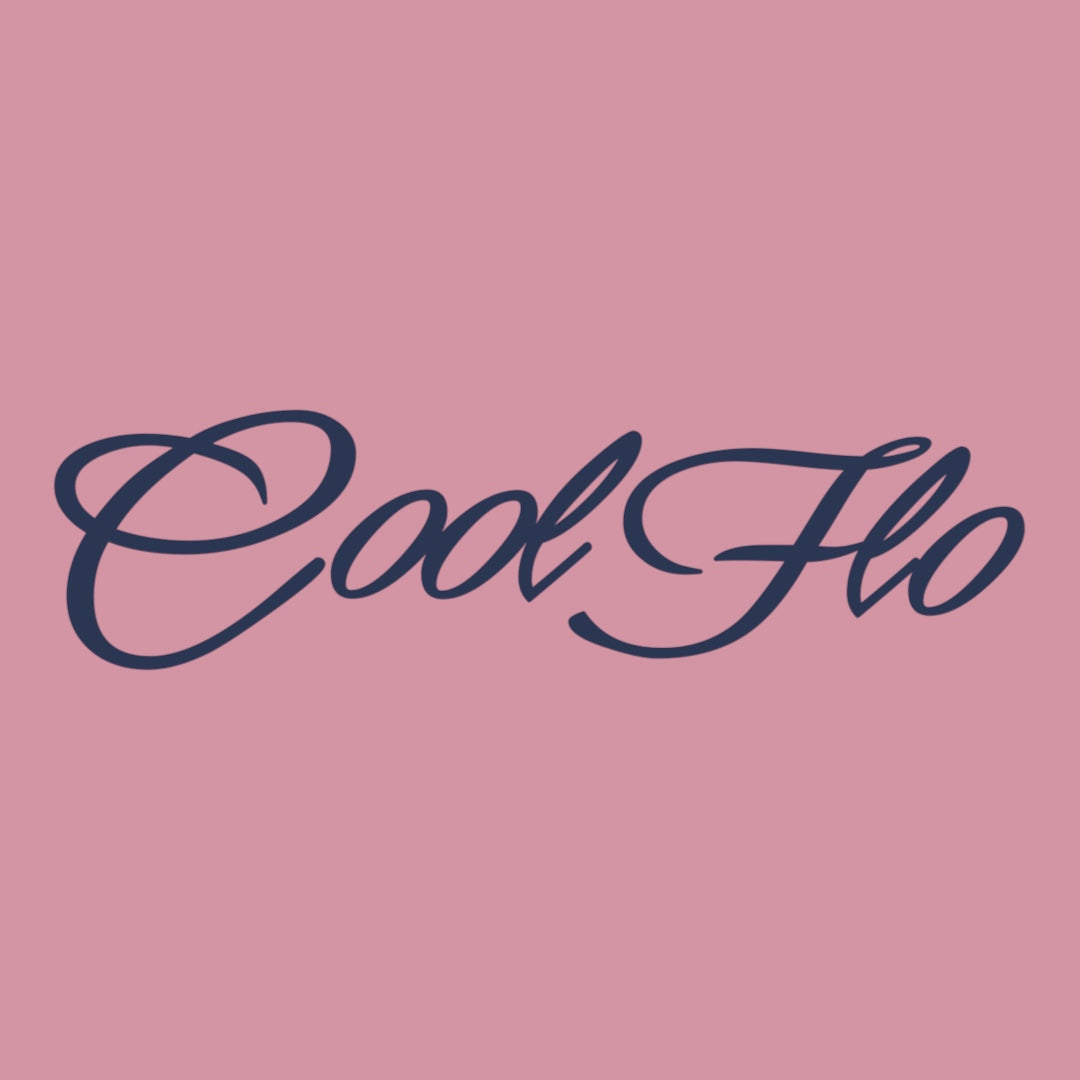 Close up of the Cool Flo Script Logo in navy blue on a pink t-shirt.