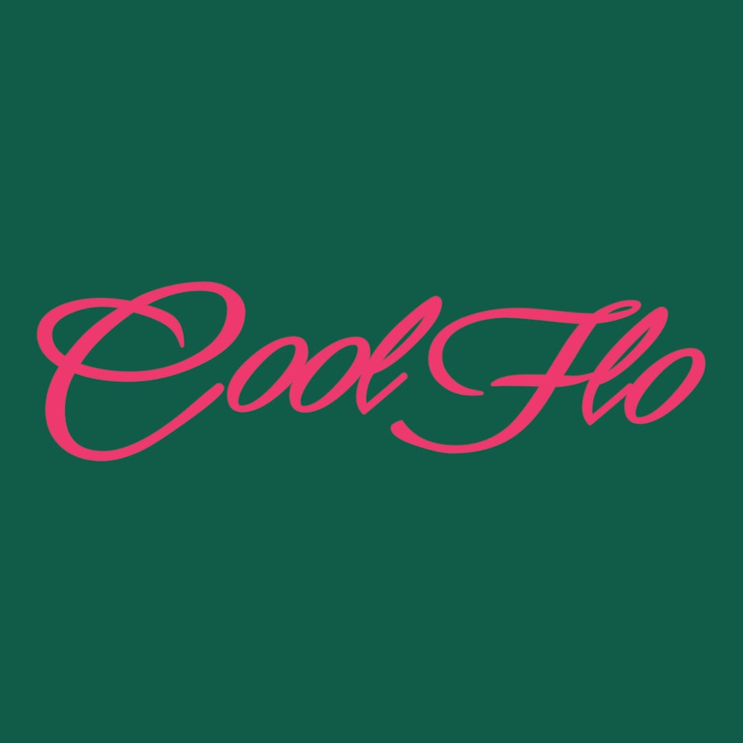 Close up of the Cool Flo Script Logo in fuschia pink on a green t-shirt.