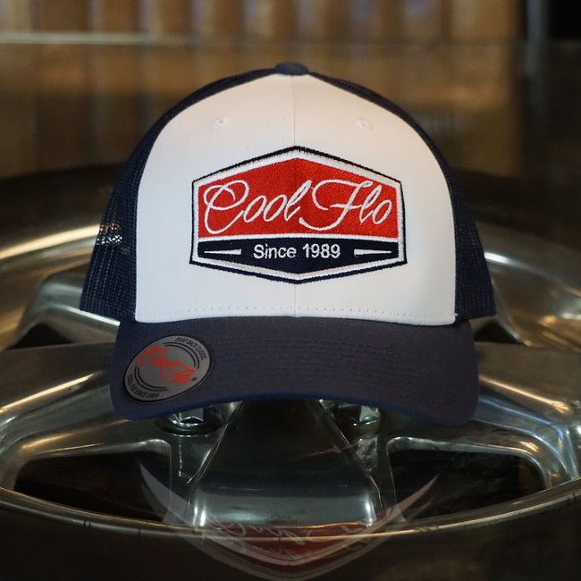 Cool Flo Navy Blue and white contrast trucker cap with navy, red and white embroidered badge design on the front.Cool Flo - Since 1989