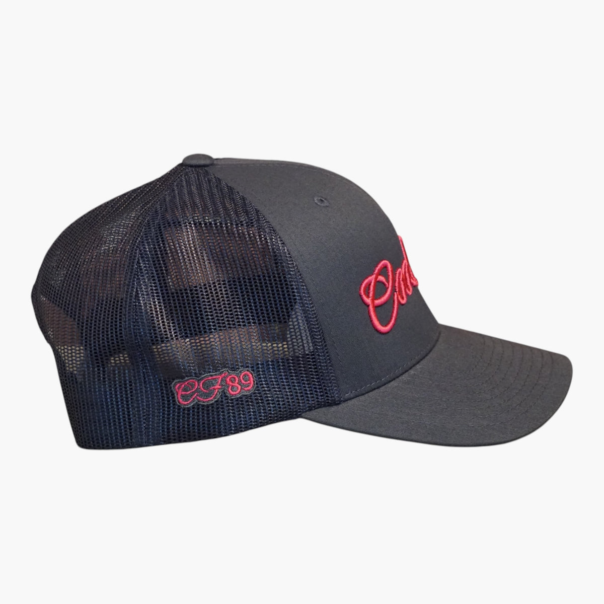 Side view of a Cool Flo Black/Pink trucker cap featuring a raised 3D embroidered Script logo, breathable mesh back panels and CF89 embroidered side detail