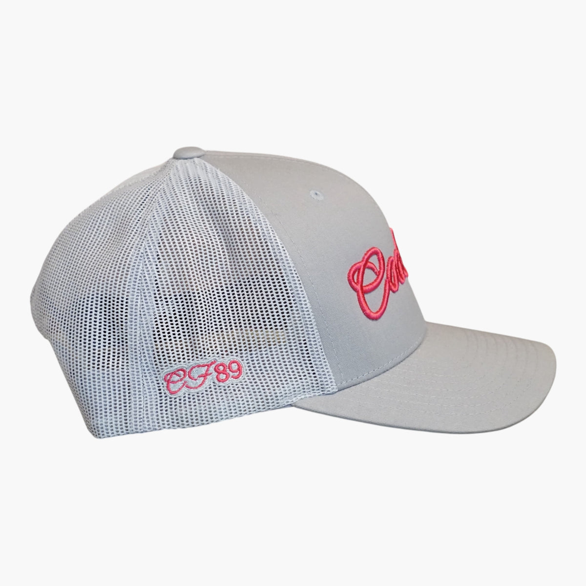 Side view of a Cool Flo Silver/Pink trucker cap featuring a raised 3D embroidered Script logo, breathable mesh back panels and CF89 embroidered side detail