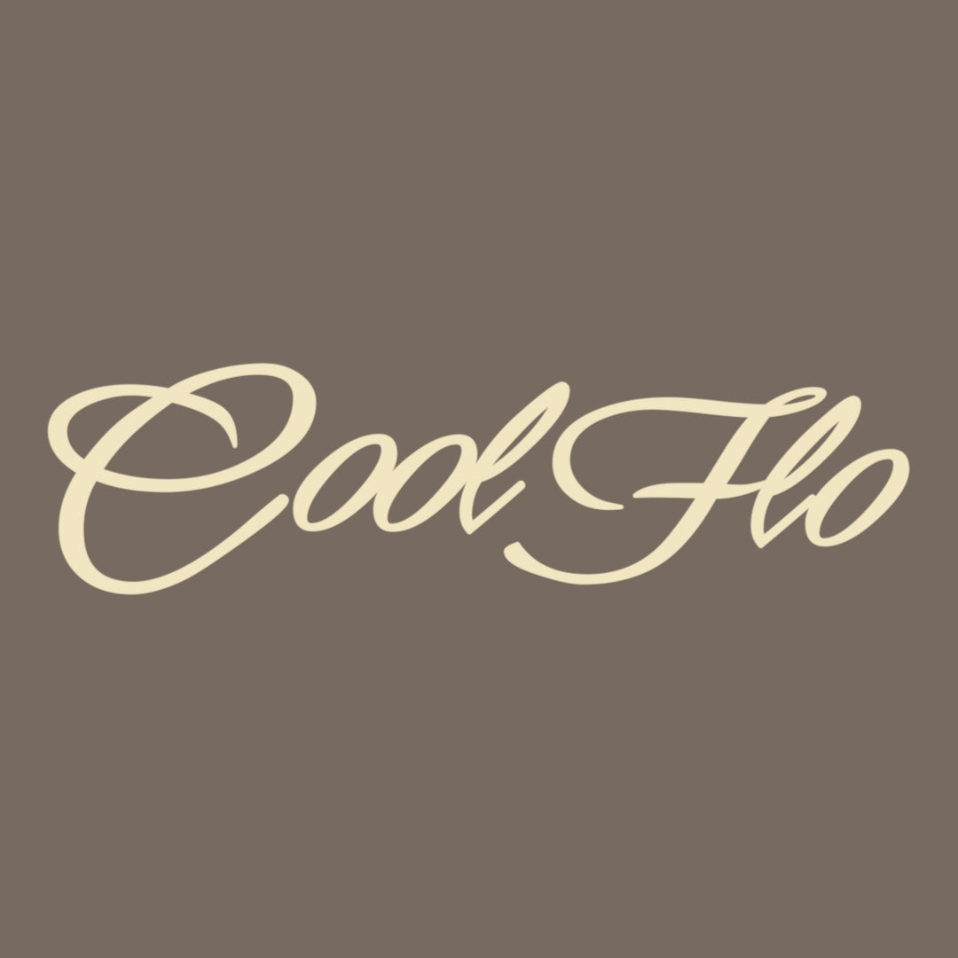 Close up of the Cool Flo Script Logo in cream on a mocha brown t-shirt.