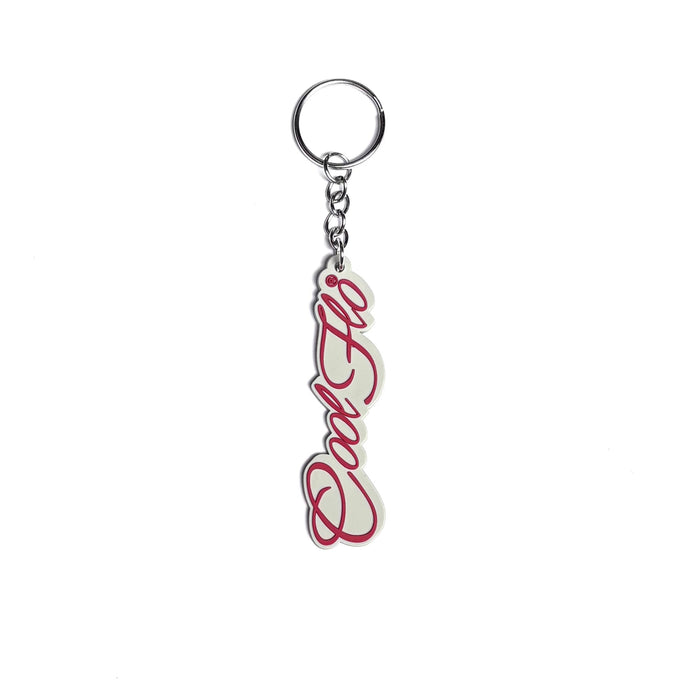 A silver metal keychain featuring the Cool Flo script logo written in red cursive script, set against a  grey/white background.