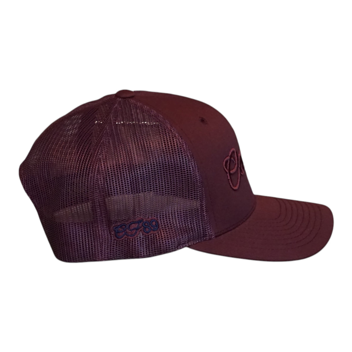 A maroon trucker-style baseball cap with a mesh back and embroidered logo details on the side and front, shown against a plain white background.