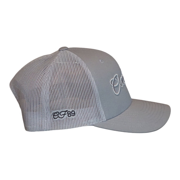Side view of a Cool Flo silver-grey trucker cap featuring a raised 3D embroidered Script logo in tonal silver-grey and a 'CF89' side-embroidery in dark grey on silver-grey.