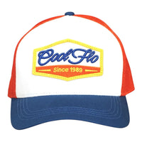 Front view of a Cool Flo Since 1989 trucker cap in White/Blue/Red featuring an embroidered Since 1989 badge in Blue, Yellow and White and a curved visor