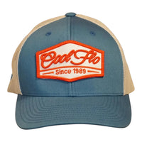 Front view of a Cool Flo Since 1989 trucker cap in Blue/Silver featuring an embroidered Since 1989 badge in Orange and White and a curved visor