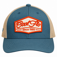Front view of a Cool Flo Since 1989 trucker cap in Blue/Silver featuring an embroidered Since 1989 badge in Orange and White and a curved visor.